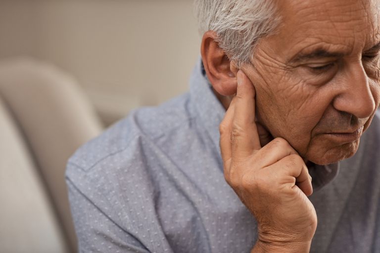 Man suffering with hearing problems