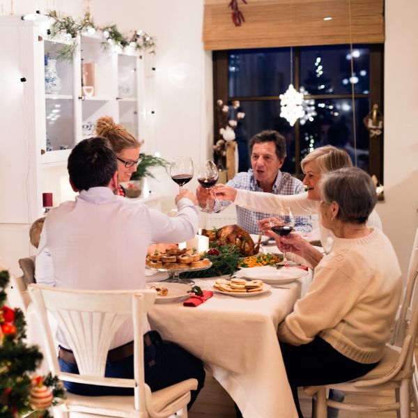 Family sitting around a table eating Christmas dinner