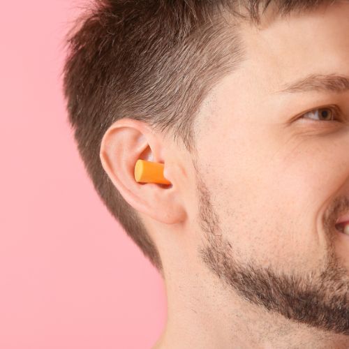 Man with ear plugs in