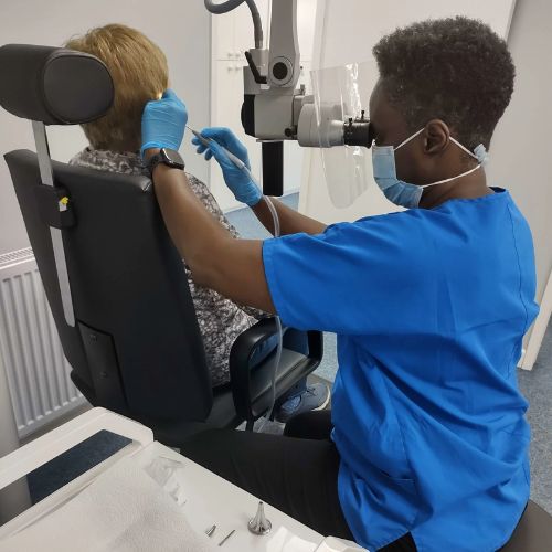 Audiologist looking in a patients ear