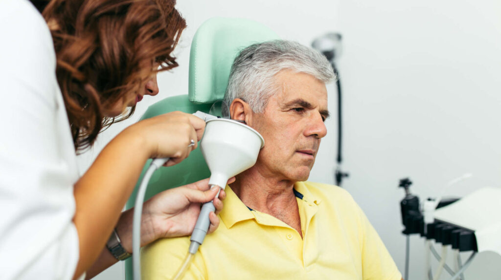 Older man getting his ear irrigated