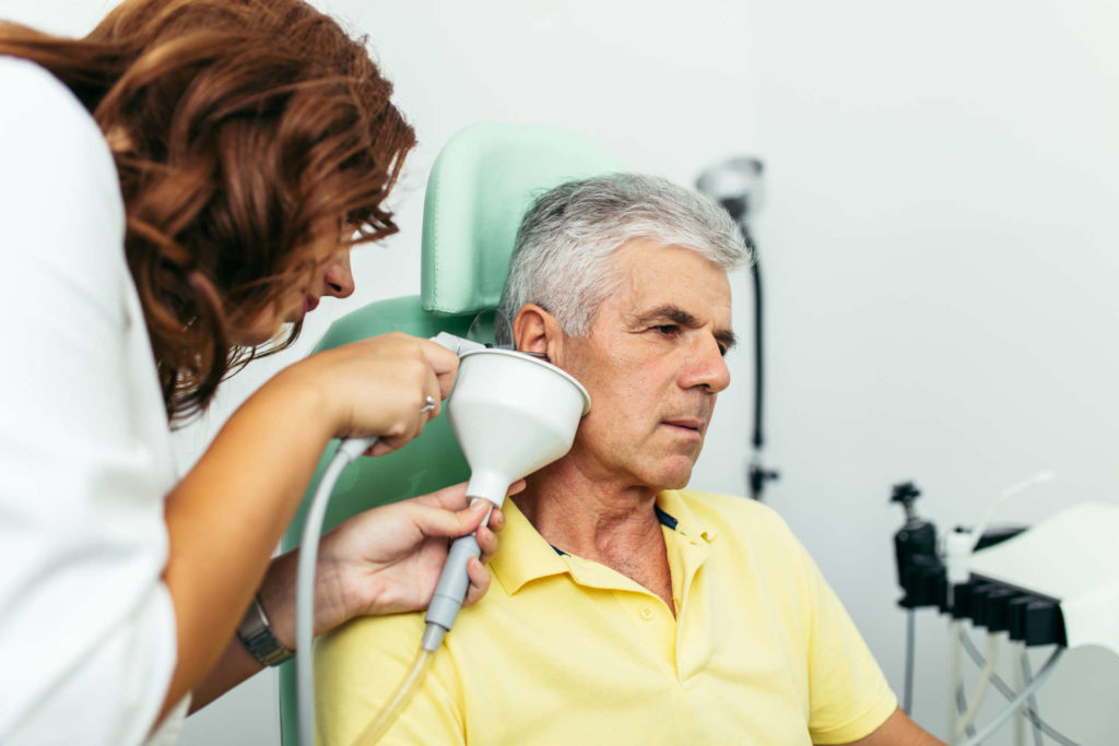 Older man getting his ear irrigated