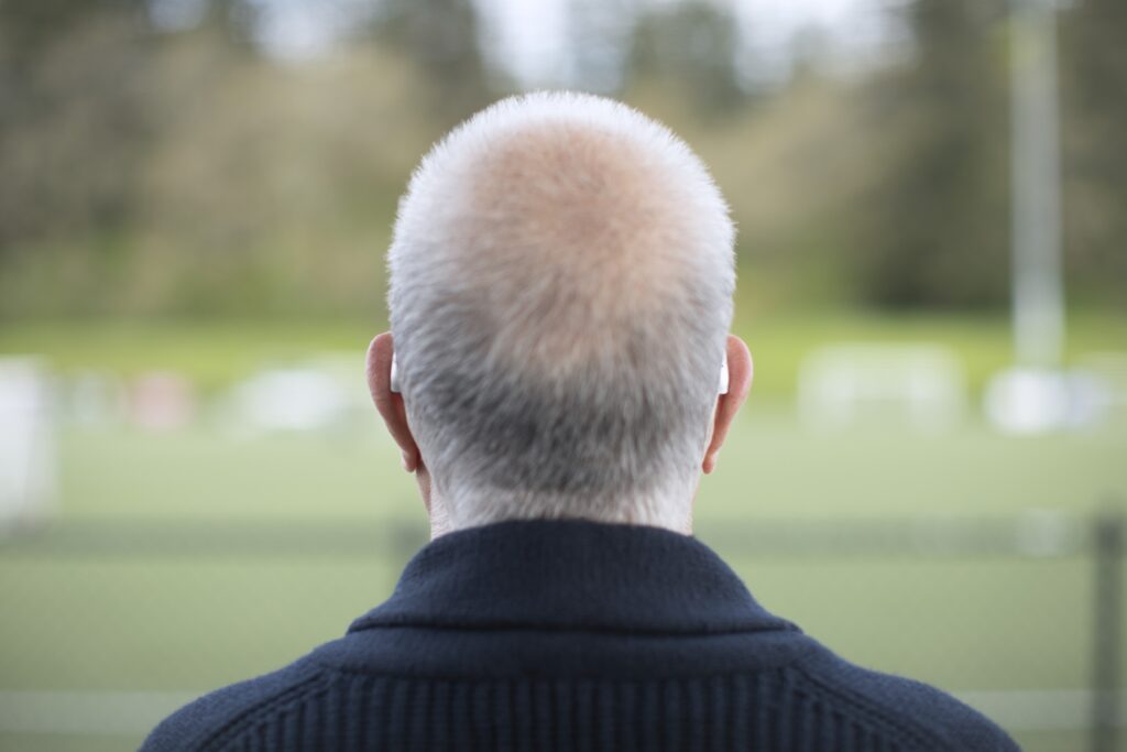 man wearing behind the ear (BTE) hearing aids 