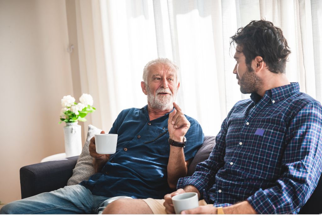 Two men chatting on a sofa