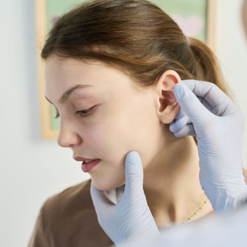 female having her ear examined