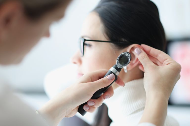 doctor examining patients ear